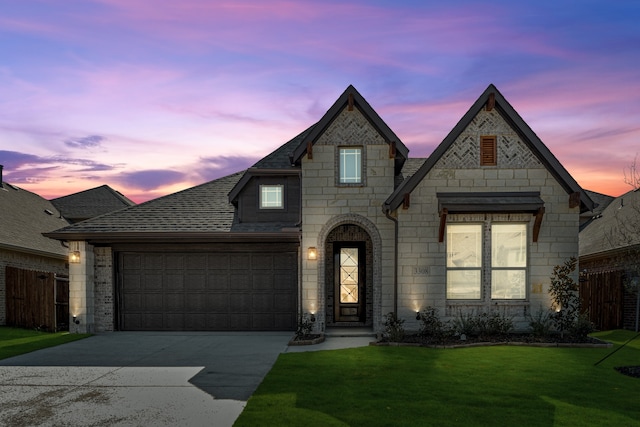 view of front of home featuring a lawn and a garage