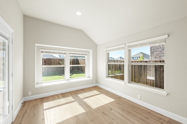 unfurnished sunroom with lofted ceiling and plenty of natural light