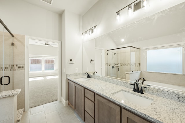 bathroom featuring vanity, ceiling fan, plus walk in shower, and tile patterned flooring