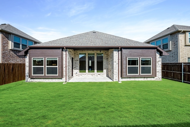 back of house featuring a patio area and a lawn