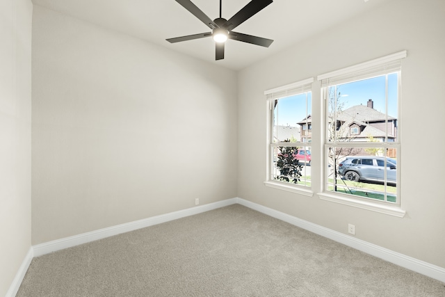 carpeted spare room with ceiling fan