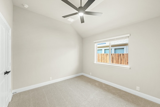 spare room featuring ceiling fan, vaulted ceiling, and carpet floors