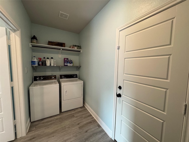 2813 Catfish Ct, Granbury, TX 76048 - washroom with washer and clothes dryer and light wood-style floors
