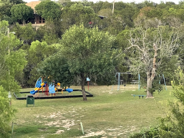 view of home's community featuring a playground and a lawn