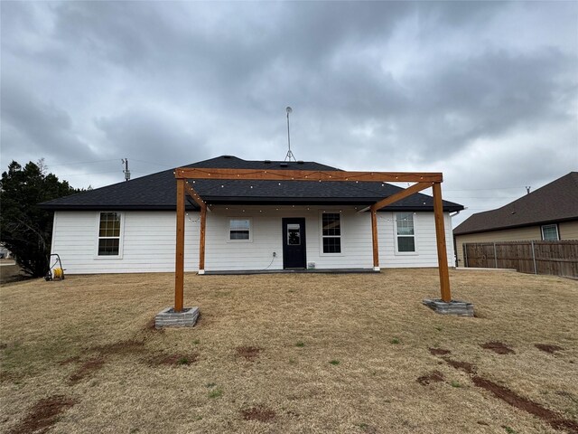 rear view of house with a yard