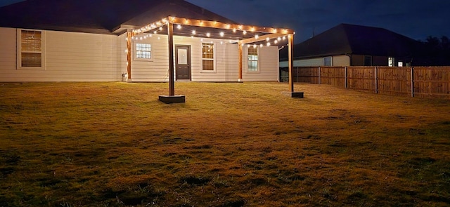2813 Catfish Ct, Granbury, TX 76048 - yard at night featuring a fenced backyard