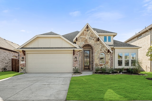 view of front of house featuring a garage and a front lawn