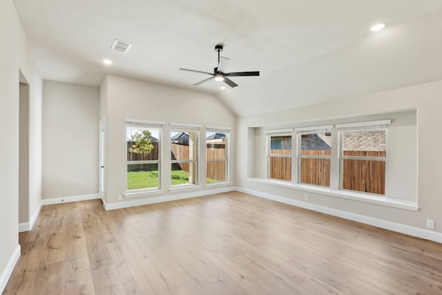 unfurnished sunroom with ceiling fan and vaulted ceiling