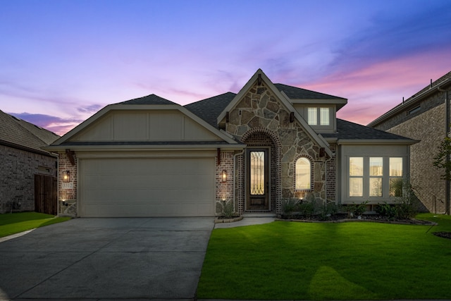 view of front of home with a yard and a garage