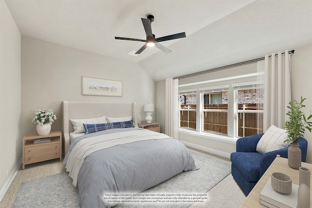 carpeted bedroom with ceiling fan and lofted ceiling