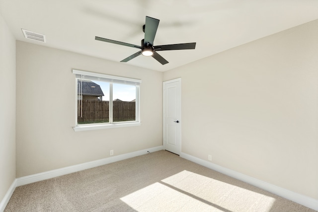 carpeted spare room featuring ceiling fan