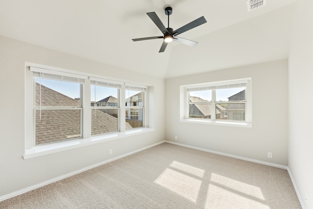 spare room featuring ceiling fan, carpet flooring, and lofted ceiling