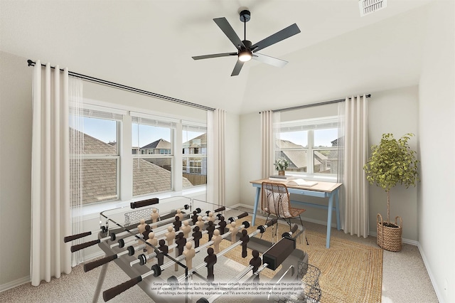 exercise area featuring light colored carpet and ceiling fan