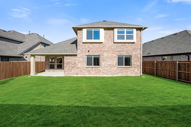 rear view of house with a patio and a lawn