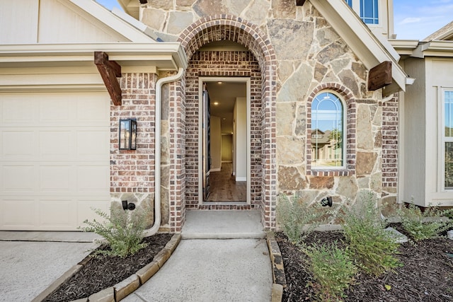 view of exterior entry with a garage