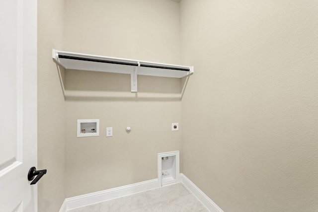 washroom featuring hookup for an electric dryer, light tile patterned floors, gas dryer hookup, and hookup for a washing machine