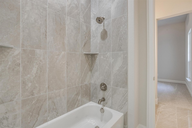 bathroom featuring tiled shower / bath and tile patterned floors