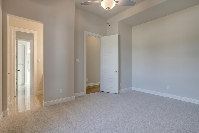 unfurnished bedroom featuring light colored carpet and ceiling fan