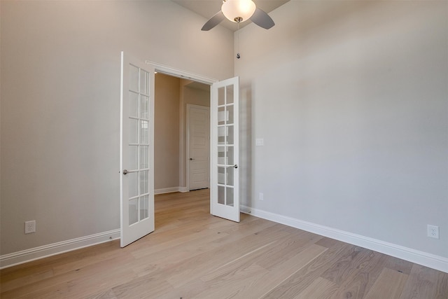 unfurnished room with french doors, light wood-type flooring, and ceiling fan