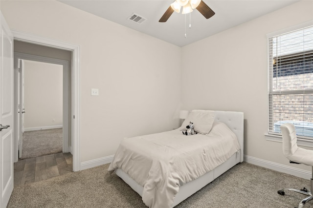 11024 Los Alamos Dr, Aubrey, TX 76227 - carpeted bedroom with baseboards, ceiling fan, and wood finished floors