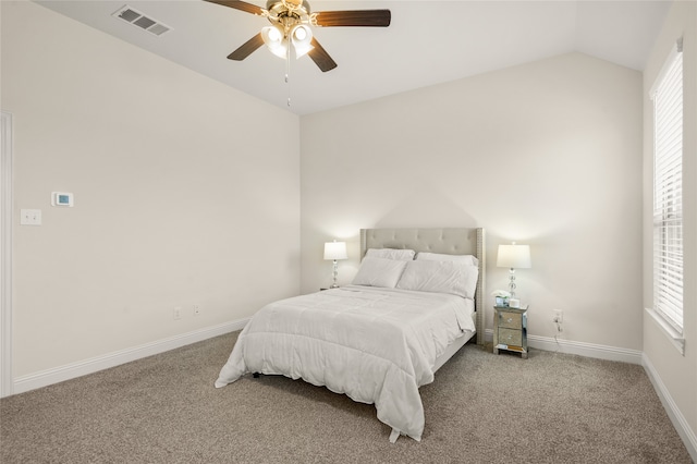 carpeted bedroom featuring ceiling fan and vaulted ceiling