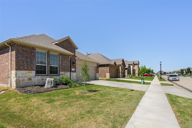 view of front facade with a garage and a front lawn