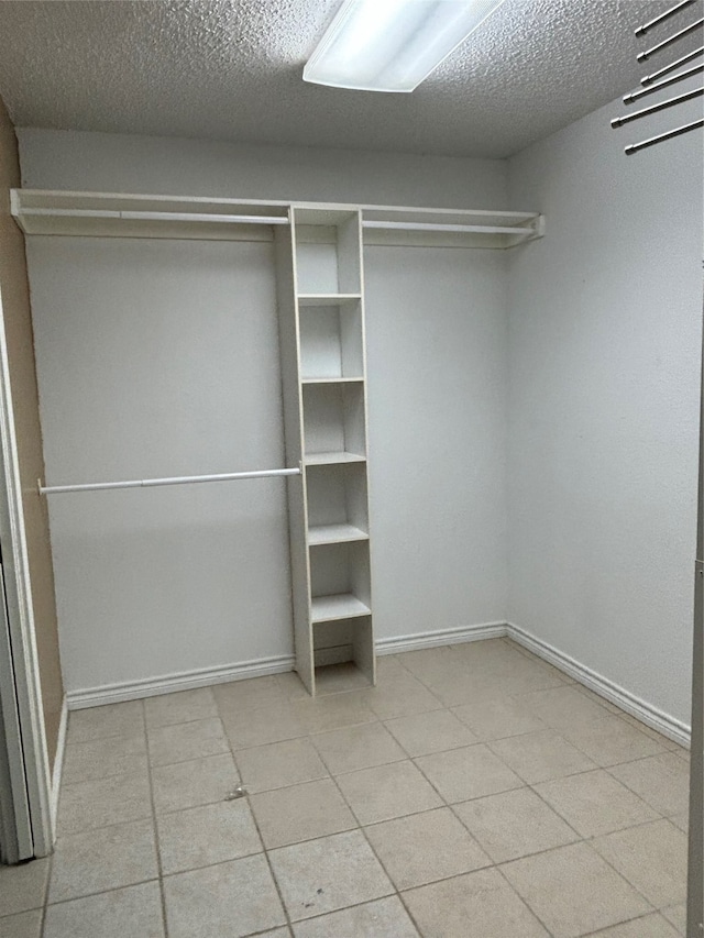 spacious closet with light tile floors