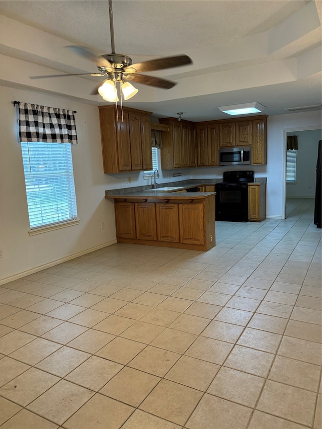 kitchen featuring black appliances, sink, light tile flooring, and ceiling fan