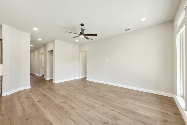 unfurnished living room featuring ceiling fan and light hardwood / wood-style flooring