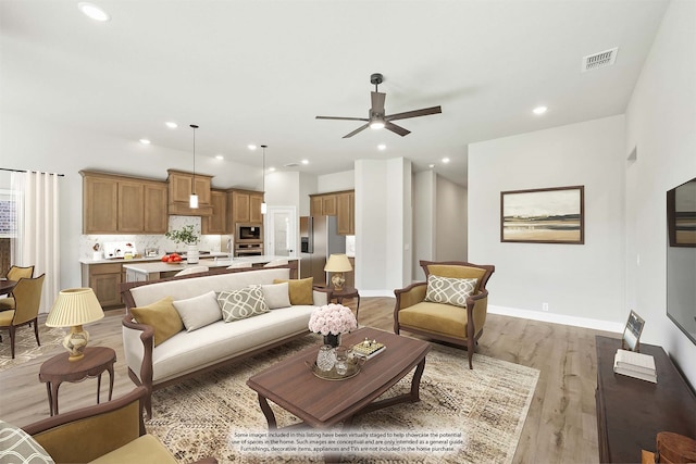 living room with hardwood / wood-style flooring and ceiling fan