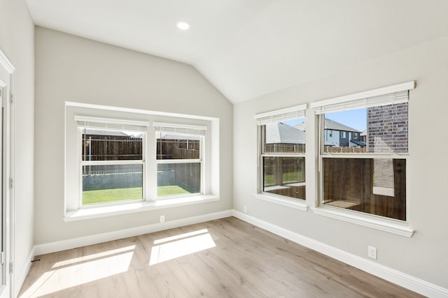 interior space with light hardwood / wood-style floors and vaulted ceiling