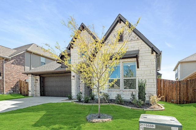 view of front of house featuring a front yard and a garage