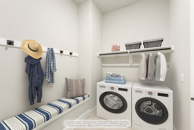 washroom with washing machine and clothes dryer