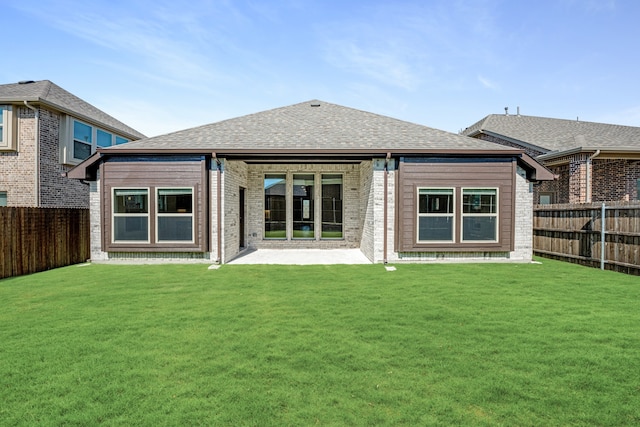 rear view of property featuring a patio and a lawn