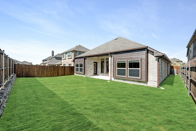 rear view of house with a yard