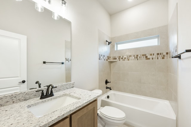 full bathroom with toilet, tiled shower / bath, and vanity