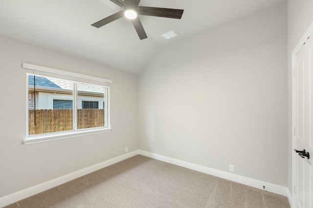 carpeted empty room with ceiling fan and lofted ceiling