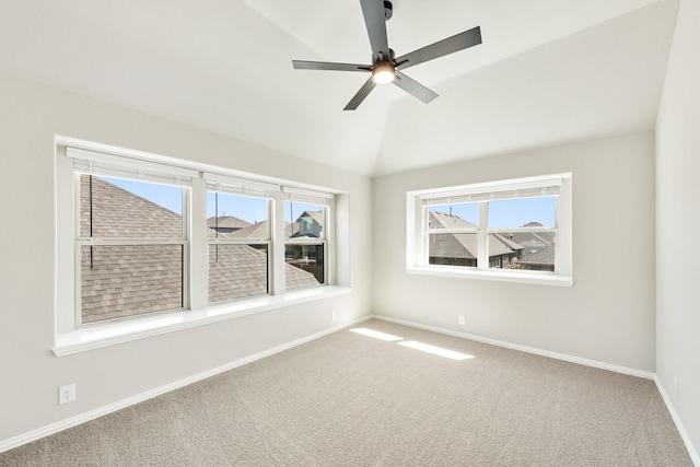 carpeted empty room featuring lofted ceiling and ceiling fan