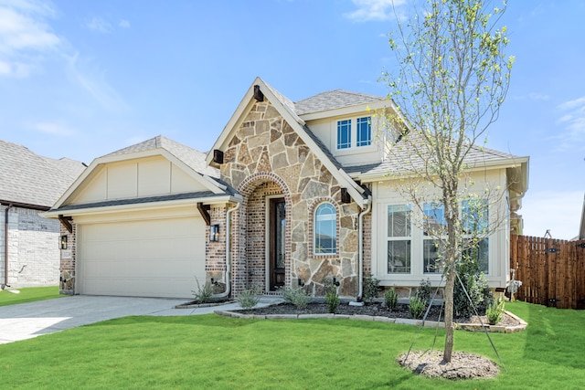 view of front of home featuring a front yard and a garage