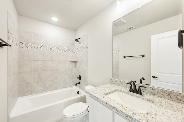 full bathroom with vanity, toilet, and tiled shower / bath combo