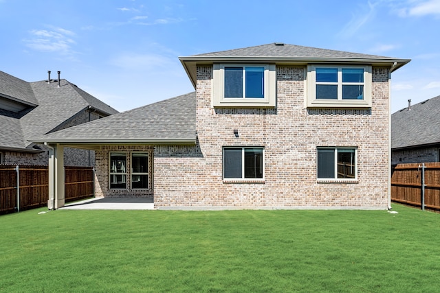 rear view of house featuring a patio area and a lawn