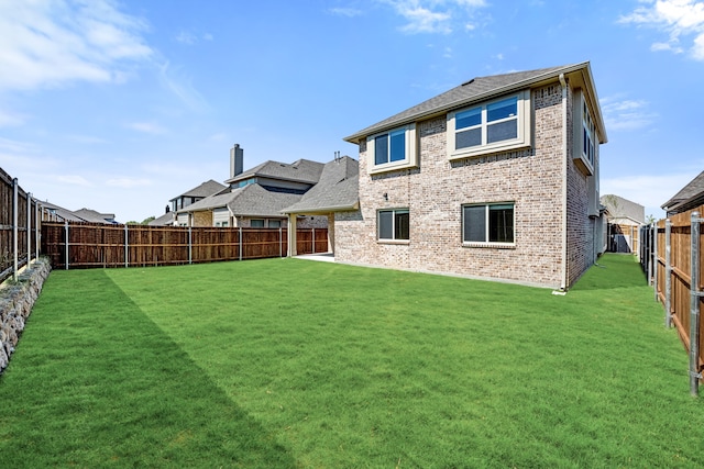 back of house featuring a lawn