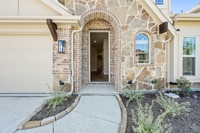 doorway to property with a garage