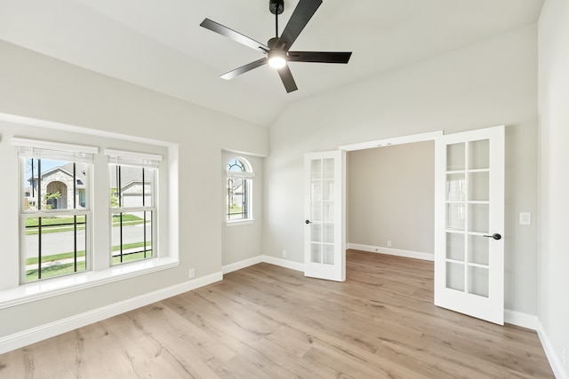 unfurnished room featuring french doors, light hardwood / wood-style floors, a healthy amount of sunlight, and ceiling fan