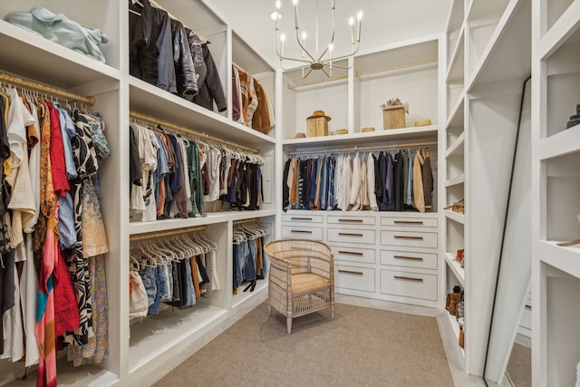 spacious closet with carpet floors and a chandelier