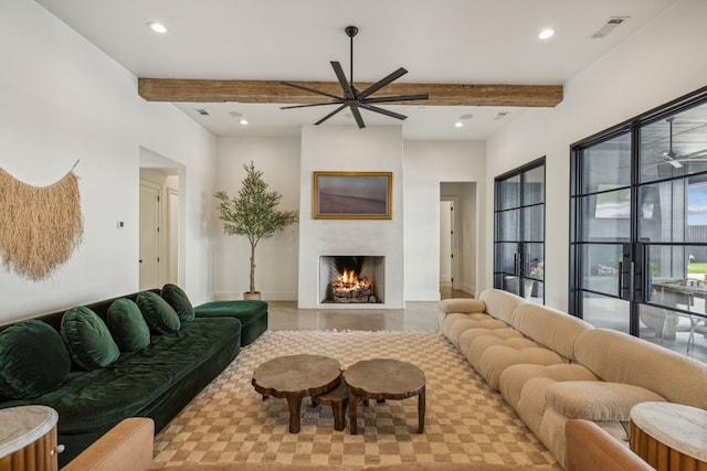 living room with ceiling fan and beamed ceiling