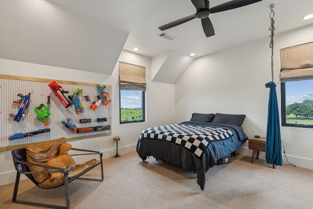 bedroom with vaulted ceiling, light colored carpet, and ceiling fan