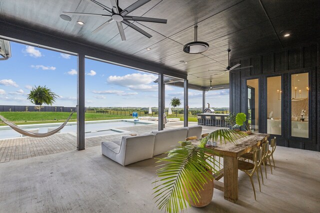 back house at dusk featuring a patio area, outdoor lounge area, and a yard