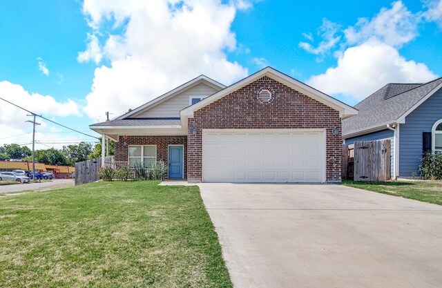 view of front of home featuring a garage and a front lawn