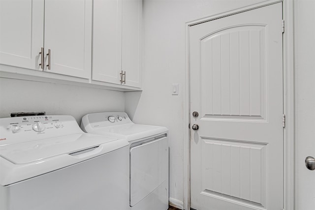 clothes washing area with cabinet space and independent washer and dryer